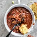 bowl of chili with beans and cornbread