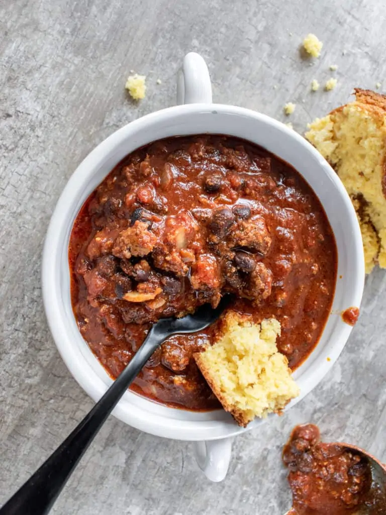 bowl of chili with beans and cornbread